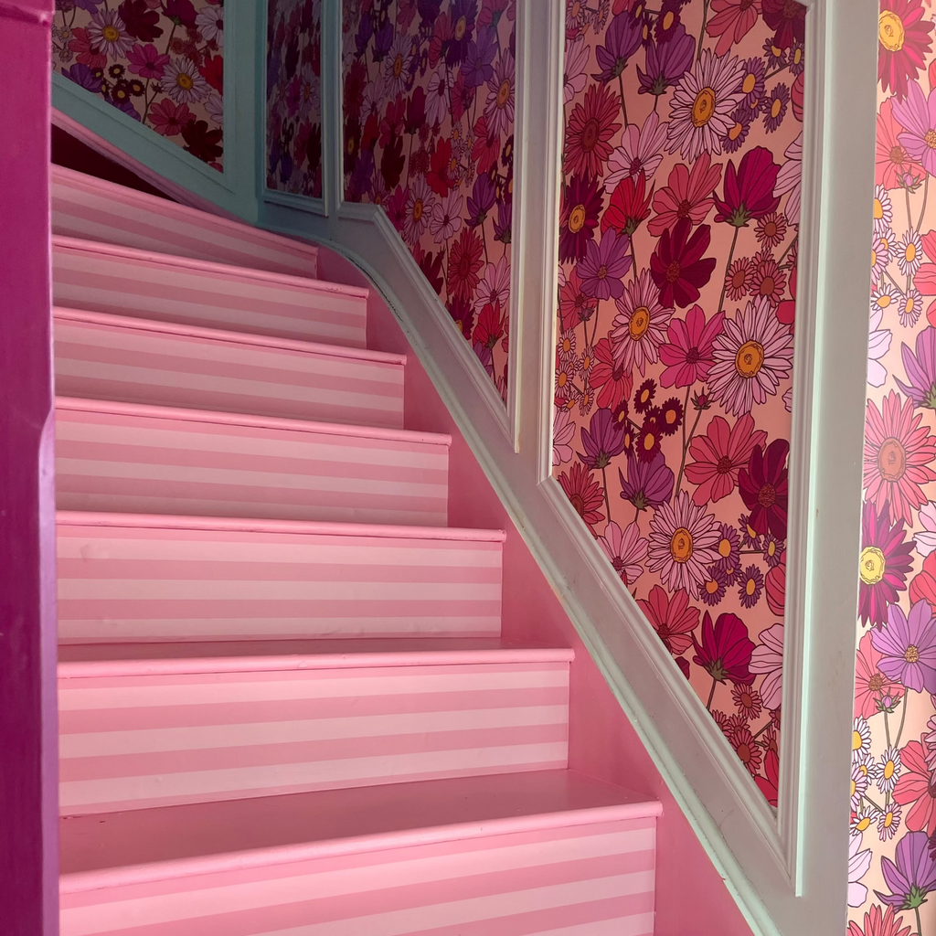 Oh So Daisy Wildflower About You Pattern on vinyl displayed in a pink hallway with striped stair risers