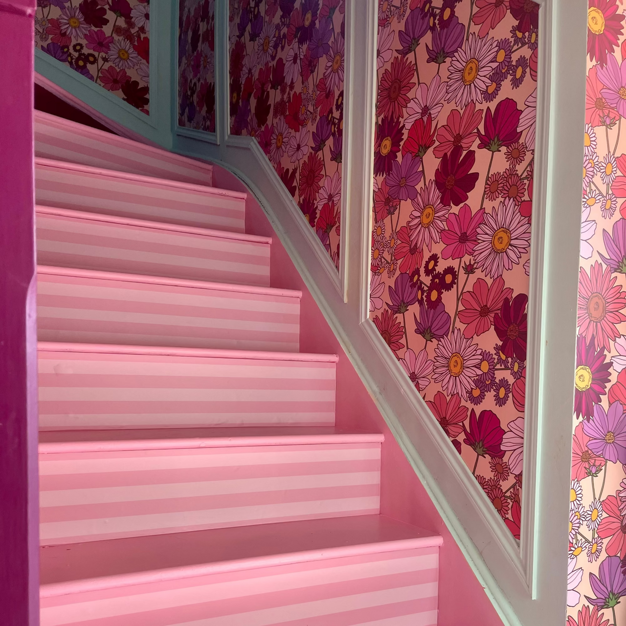 Oh So Daisy Wildflower About You Pattern on vinyl displayed in a pink hallway with striped stair risers
